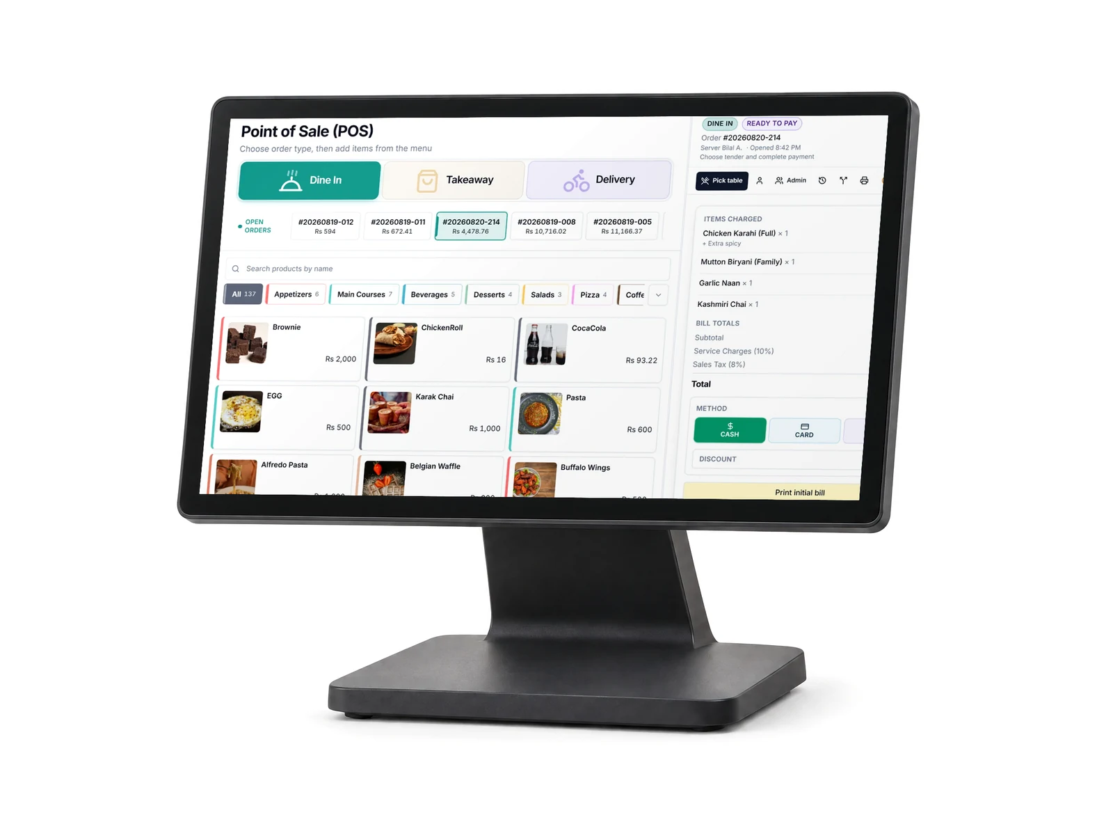 A countertop touchscreen terminal showing the Bhookly point of sale, with the menu on the left and an itemised bill on the right